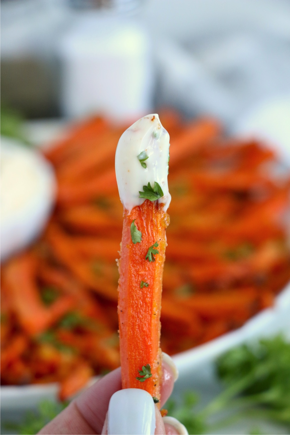 single carrot fry with dipping sauce on end