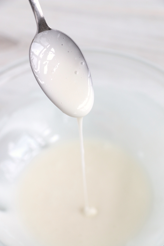 drizzles of icing off of a spoon