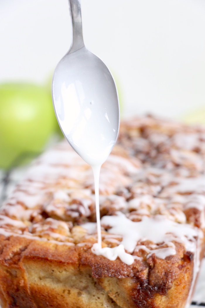 using a spoon to drizzle icing with a spoon