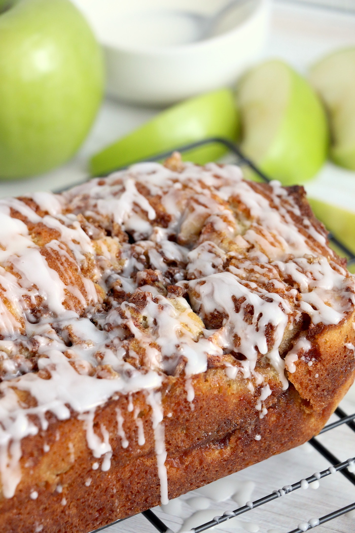 loaf of apple bread drizzled with vanilla icing