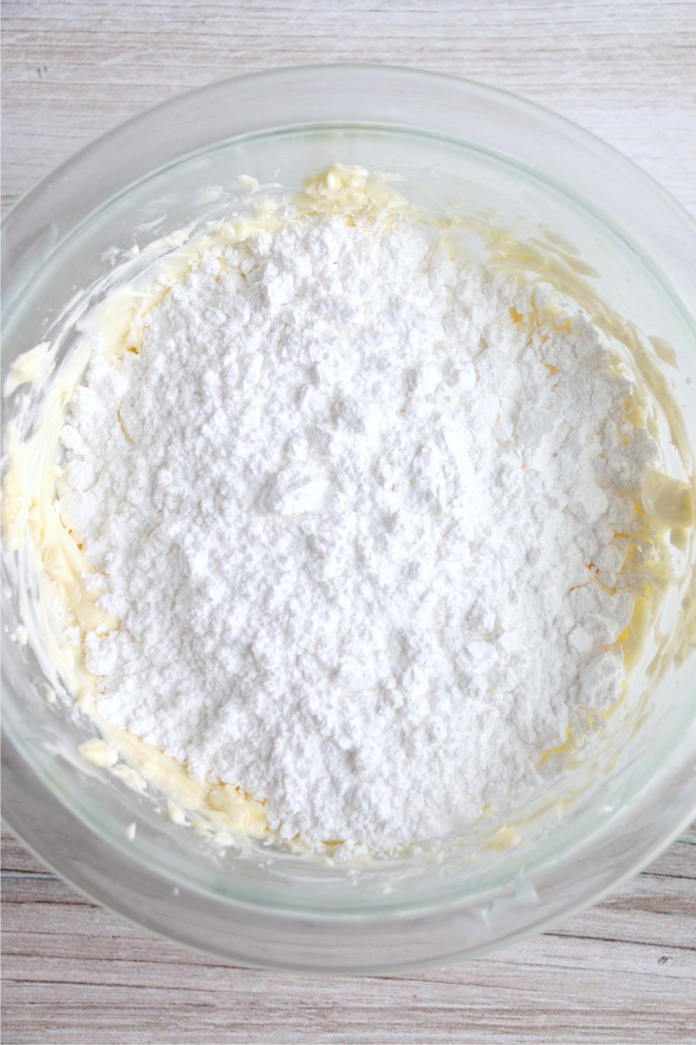 powdered sugar  on top of cream cheese and butter mixture