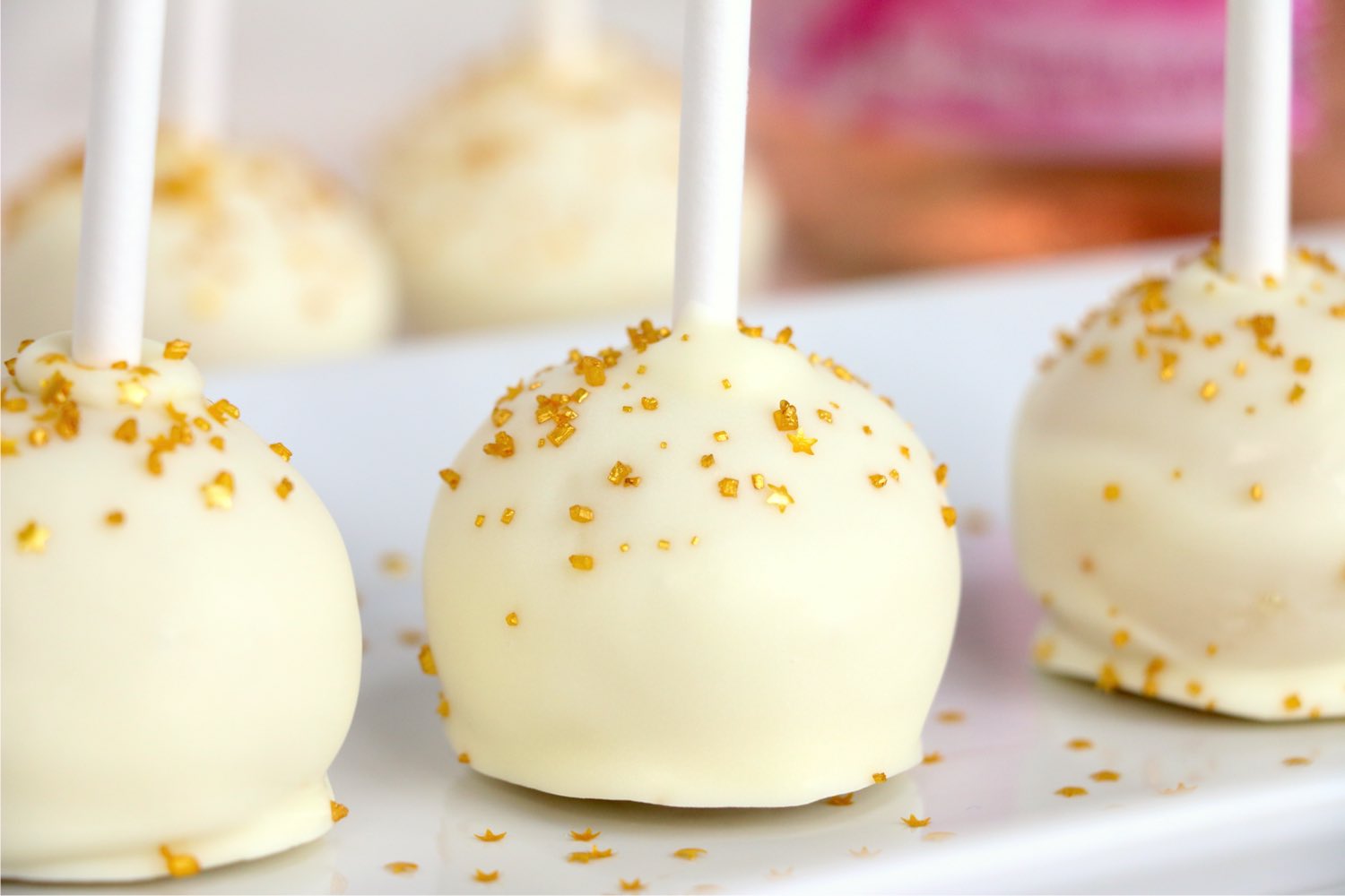 row of cake pops on a white platter