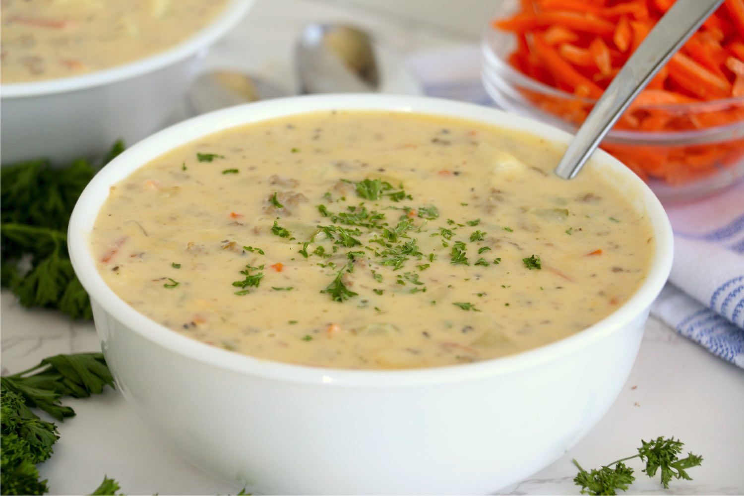 bowl of cheeseburger soup with parsley garnish
