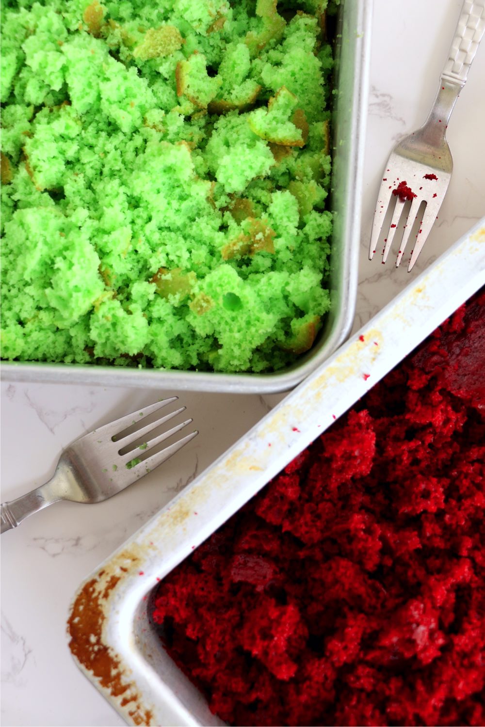 Crumbled red and green  cake in 13x9-inch pans.