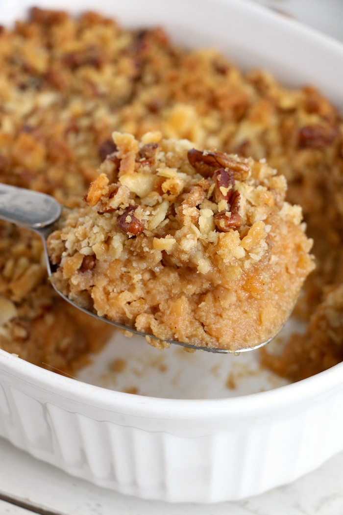 Easy Sweet Potato Casserole - An easy and delicious casserole that comes together with no scrubbing, boiling or baking the sweet potatoes! Topped with a sweet, salty and crunchy streusel, your guests will devour this simple and tasty side dish!