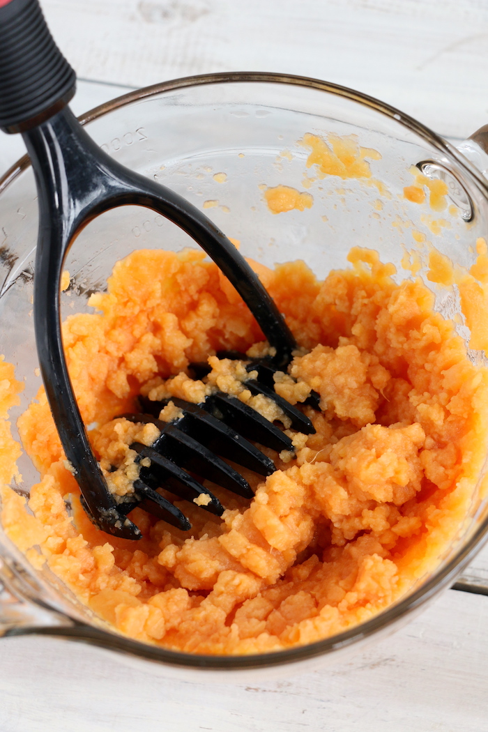 Easy Sweet Potato Casserole - An easy and delicious casserole that comes together with no scrubbing, boiling or baking the sweet potatoes! Topped with a sweet, salty and crunchy streusel, your guests will devour this simple and tasty side dish! 
