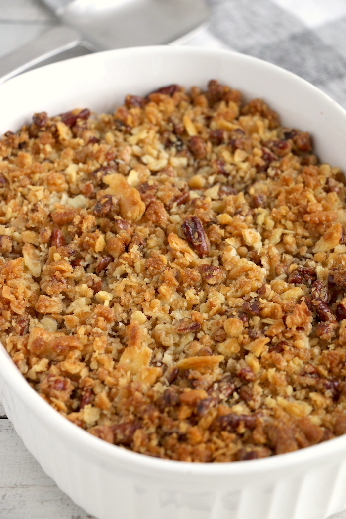 Easy Sweet Potato Casserole - An easy and delicious casserole that comes together with no scrubbing, boiling or baking the sweet potatoes! Topped with a sweet, salty and crunchy streusel, your guests will devour this simple and tasty side dish!