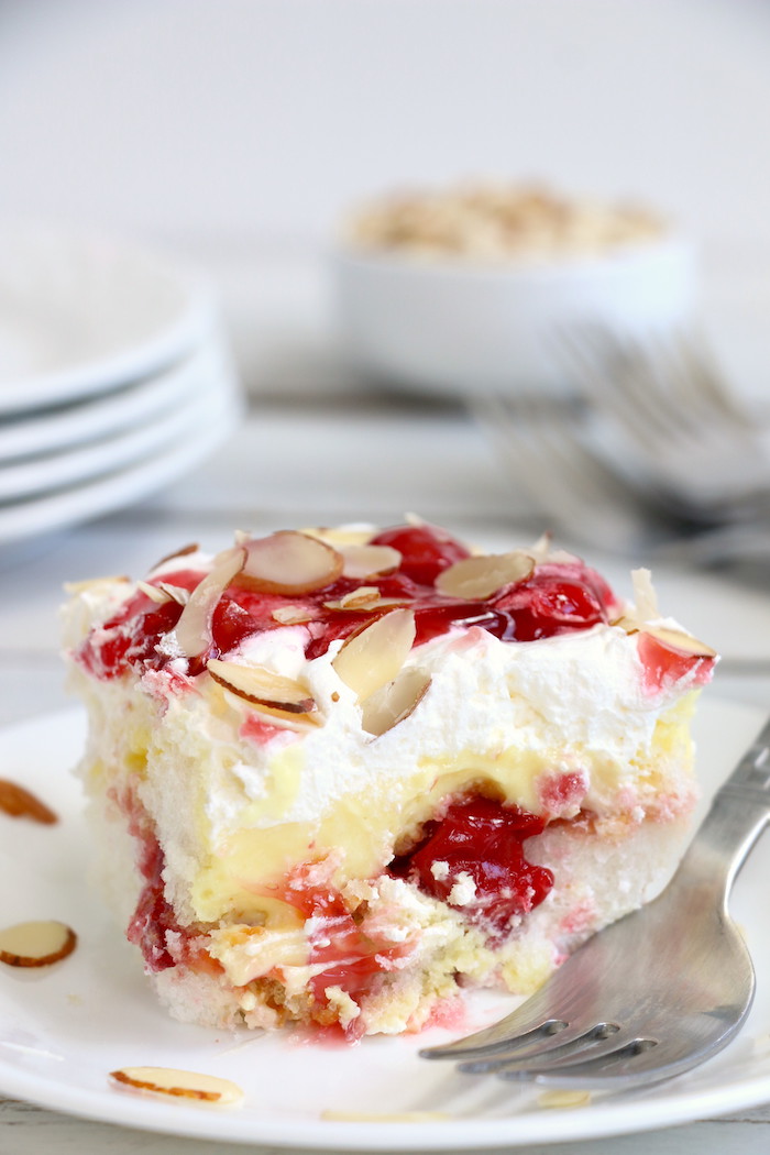 No Bake Cherry Dump Cake - An easy, no-bake cherry trifle dessert withÂ layers of angel food cake, sour cream, pudding, cherry pie filling and whipped topping.