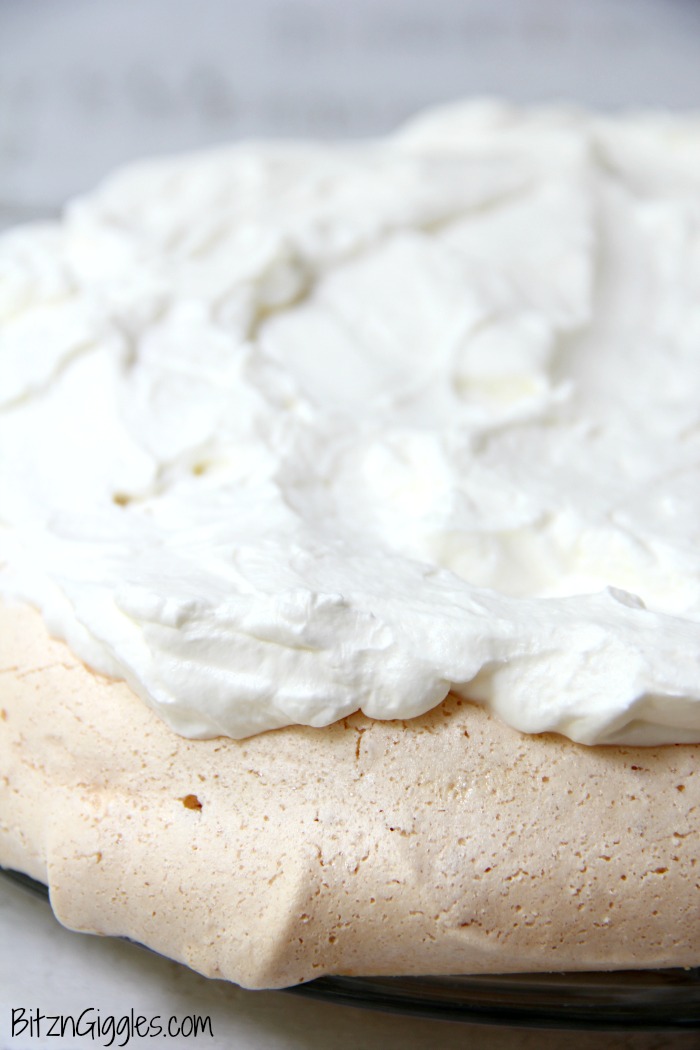 Triple Berry Pavlova - This meringue cake is crisp on the outside and soft and light on the inside! Topped with homemade whipped cream and fresh berries, it's such an elegant, light and delicious dessert!