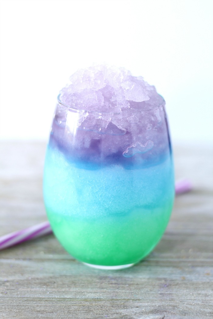 Mermaid Slush - A fun and colorful kid-friendly layered drink perfect for birthdays and parties! #slush #kidsdrink #slushie #BitznGiggles #mermaid #recipe #drinkrecipes #drinks #nonalcoholicdrinks #slushies 