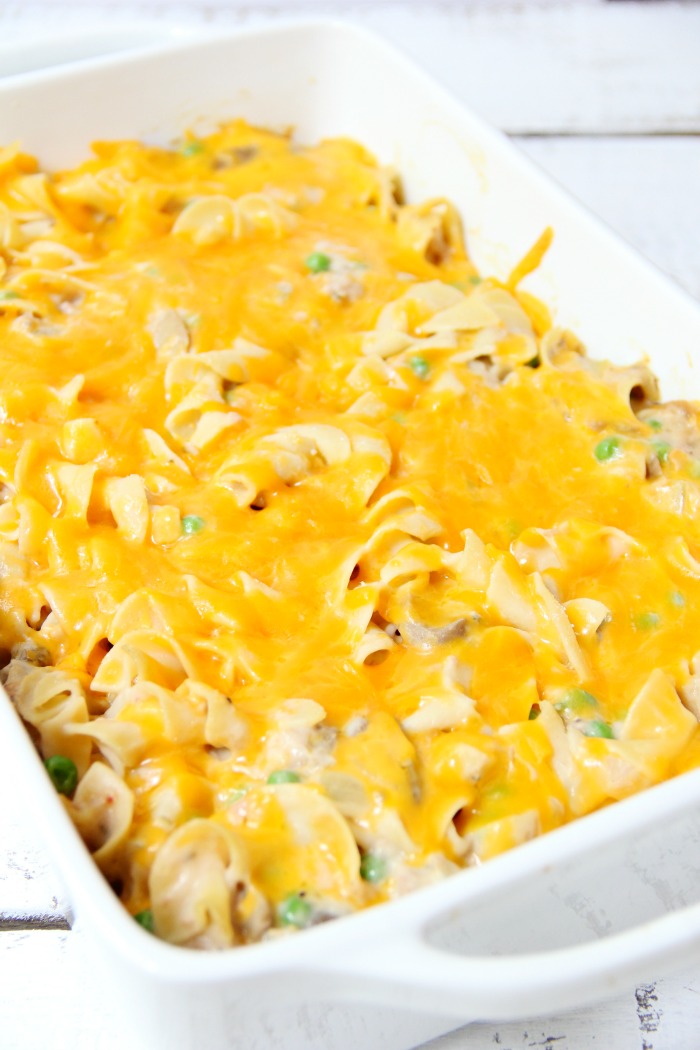 Classic Tuna Noodle Casserole - Ready in under 45 minutes, this classic and comforting casserole features tuna, onions, mushrooms, peas and cheese in a creamy sauce topped with more cheese and crunchy French fried onions! So flavorful, and sure to satisfy the entire family! 