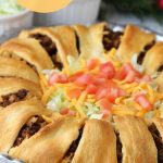 Ultimate Crescent Roll Taco Ring - This isn't just a taco ring, it's filled with guacamole, sour cream, cheese and tomatoes - easy and delicious, ready to serve a crowd!