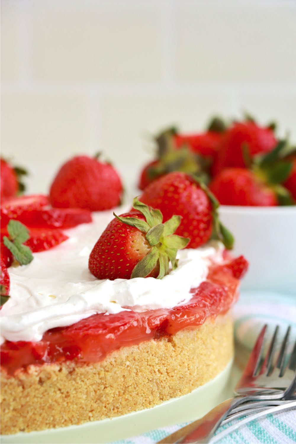 side shot of a frosted strawberry pie